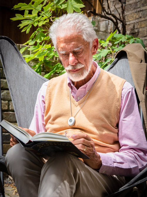 Senior man with a digital personal alarm