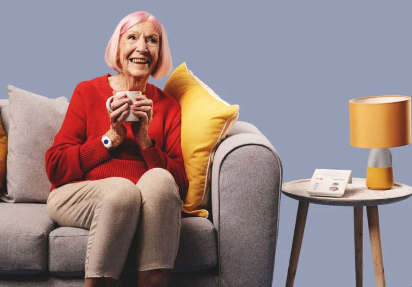 Lady with pink hair wearing a fall alarm